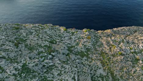 Epic-green-gray-landscape-of-Sa-Falconera-Menorca-Spain-cliffs-at-sunset-by-the-ocean