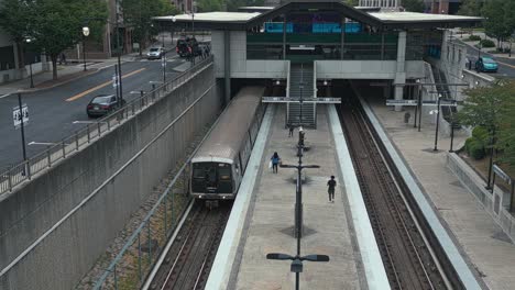 Passenger-leaving-metro-at-Lindbergh-Marta-Station-in-Atlanta-City---aerial-orbit-shot