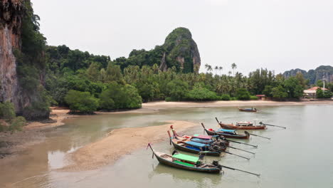 Aerial-View-of-Long-Tail-Boats-Docked-at-Railay-Beach-in-Krabi,-Thailand
