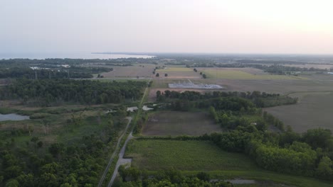 Endless-countryside-near-Lake-Erie-and-haze-from-Canadian-wild-fires,-aerial-drone-view