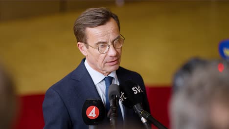 Swedish-Prime-Minister-Ulf-Kristersson-explaining-himself-at-the-European-Council-summit-in-Brussels,-Belgium---Slow-motion-medium-shot