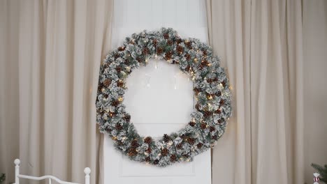 Snowy-pinecone-wreath-with-twinkling-lights