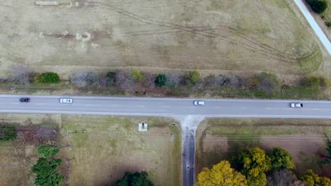 This-video-shows-a-drone-flying-overhead-following-some-cars-driving-on-a-country-road