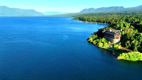 Vibrant-Colors-Landscape-over-Villarrica-Lake-and-Luxurious-Hotel-with-Mountains,-Chile