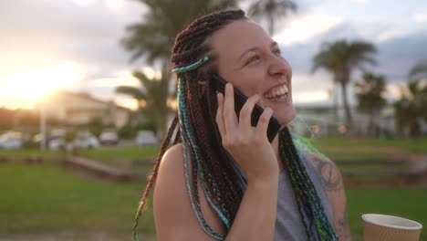 woman-with-braids-and-smile-talking-on-smartphone