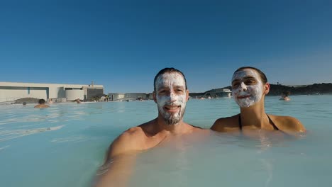 Close-up-shot-of-a-couple-relaxing-in-the-blue-lagoon-spa-with-facemasks