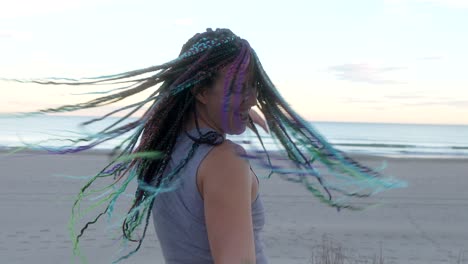 woman-with-braids-dancing-on-the-beach