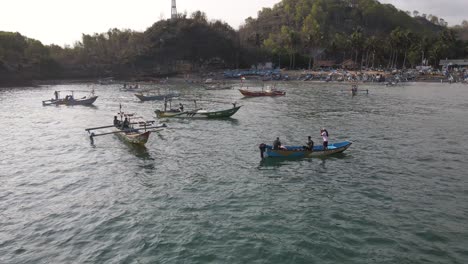 aerial-view,-several-fishing-boats-starting-to-go-to-sea-looking-for-tuna