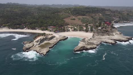 aerial-view-of-Klayar-Beach-which-has-the-charm-of-white-sand-and-beautiful-white-coral-in-Pacitan,-Indonesia