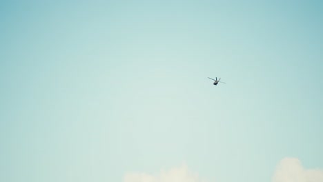slow-motion-shot-of-a-helicopter-flying-in-the-sky-making-a-right-hand-turn