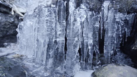 Shot-of-a-frozen-waterfall-with-spiky-icicles