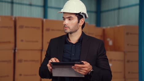 Factory-manager-using-tablet-computer-in-warehouse-or-factory