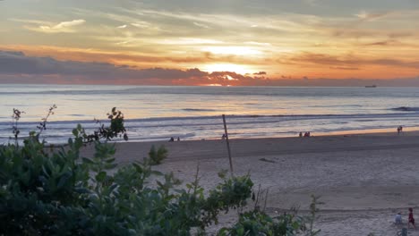 Pan-reveal-landscape-shot-of-Carcavelos-Beach-during-sunset