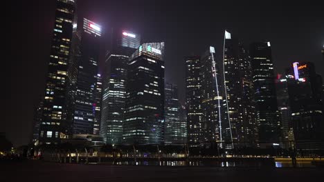 Beleuchtete-Bürogebäude-Im-Finanzviertel-In-Singapur-Neben-Der-Marina-Bay