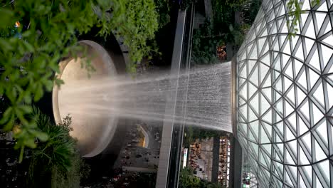 Overlooking-Amazing-Indoor-Waterfall-Cascading-Down-At-Jewel-Changi-Airport-In-Slow-Motion