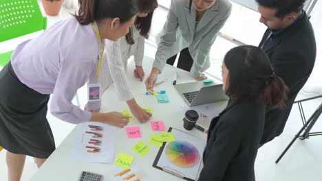 Business-people-proficiently-discuss-work-project-on-meeting-table