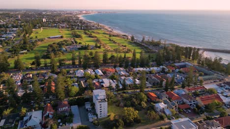 Panoramic-drone-view-of-the-scenic-Cottesloe-Beach-on-the-Indian-Ocean-during-sunset,-Perth,-Western-Australia