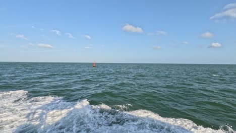 A-seascape-of-buoy-sways-and-floats-in-the-sea-as-a-safety-warning-and-navigation-marker-at-the-harbor-or-port-on-a-sunny-day