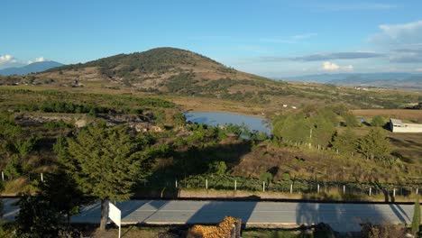 Fly-over-truck-left-establishing-in-a-natural-landscape-with-mountain-and-solitary-lagoon-in-Almoloya-in-the-state-of-Mexico