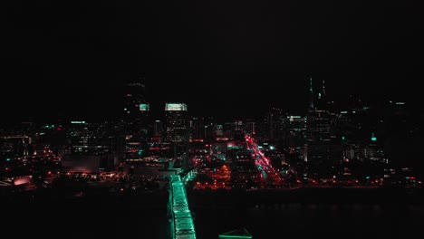 Aerial-drone's-panning-view-over-city-landscape-with-lights-and-skyscrapers