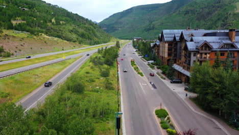 Aerial-view-flying-along-interstate-70,-cloudy,-summer-day-in-Vail,-Colorado,-USA