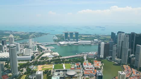 Daytime-aerial-capture-of-Singapore-Marina-Bay-area,-modern-architectural-marvels,-vibrant-cityscape-and-the-bustling-waterfront-that-define-Marina-Bay