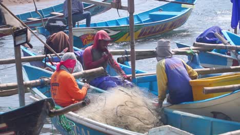 The-fishermen-are-making-repairs-to-the-fishing-net-on-the-boat