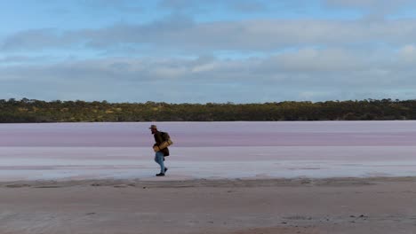 A-swagman-walks-along-a-salt-lake-in-the-vast-remote-Australian-outback