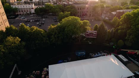 Cinematic-revealing-aerial-of-large-wedding-event-tent-on-american-football-field