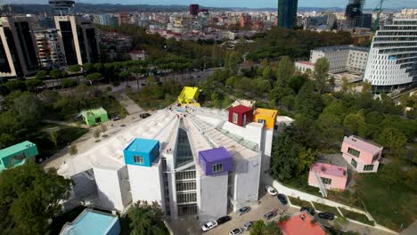 Colorful-Pyramid-of-Tirana,-a-Breathtaking-Symbol-of-Capital's-Rich-History-Amidst-Vibrant-Modern-Buildings