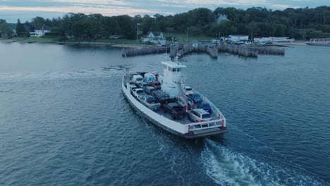 Aerial-Drone-shot-of-Ferry-approaching-Shelter-Island-North-Fork-Long-Island-New-York-before-sunrise