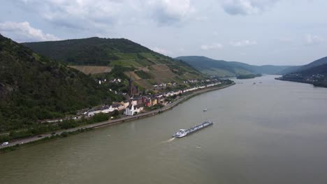 Tanker-ship-cruising-river-rhine-past-hillside-german-village-Lorchhausen
