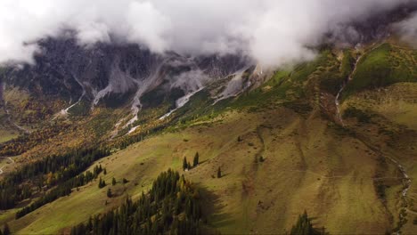 Aerial-view-of-Hochkonig-alps,-Austrian-valley-and-forest-trees,-pull-back