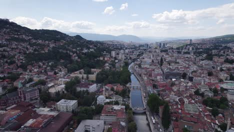 Aerial-dolly-forward-scenic-european-city-Sarajevo-old-town-and-river-miljacka