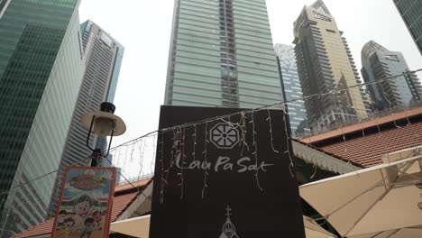 Lau-Pat-Sat-Sign-With-Hanging-LED-Lights-And-Soaring-Office-Towers-In-Background-In-Singapore-CBD