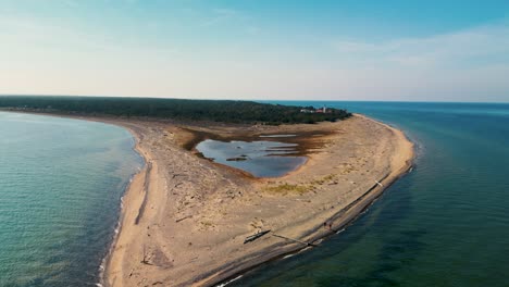 Aerial-ascent-fly-out-from-Whitefish-Point-peninsula-tip,-Michigan