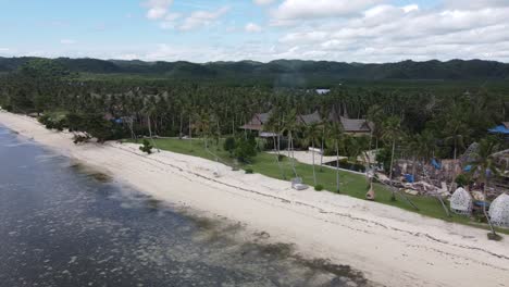 Construction-work-of-Amenities-and-traditional-huts-in-Nay-Palad-Tropical-beachfront-resort,-Siargao