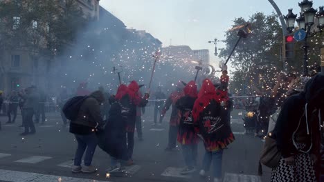 Children-dressed-as-demons-set-fire-to-flares-during-the-Correfoc-festival-in-Barcelona,-Spain