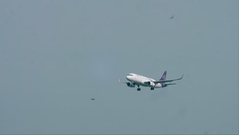 Descending-down-for-its-arrival,-the-Thai-Airways-is-preparing-to-land-on-the-runway-of-Don-Muang-airport-in-Bangkok,-Thailand