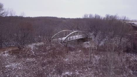 Stark-winter-aerial-approaches-abandoned-old-highway-bridge-to-nowhere
