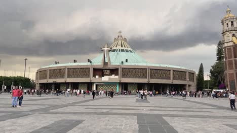 Villa-Basilica-of-Guadalupe,-visitors-and-tourists-are-seen-enjoying-the-Atrium-of-the-Americas