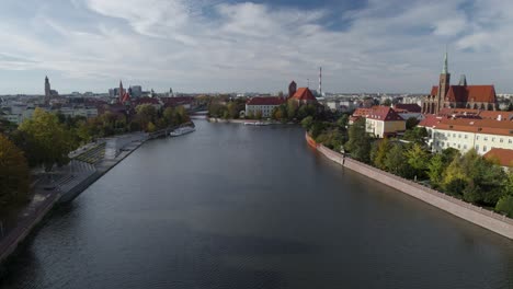 Flying-toward-the-library-on-sand-Island-passing-old-town-buildings-in-Wroclaw