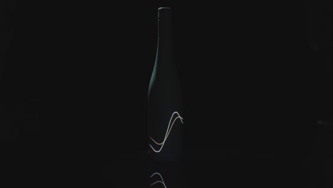 Light-Waves-Shine-On-A-Dark-Wine-Bottle