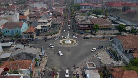 Reveal-tracking-drone-shot-of-Tugu-Yogyakarta-Monument-the-iconic-building-of-Yogyakarta-City-in-rush-hour---Cinematic-drone-movement