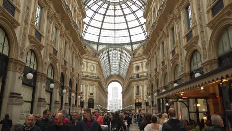 Tourists-Walk-Around-Galleria-Vittorio-Emanuele-II-with-Prada-and-Louis-Vuitton-Shops-in-Background