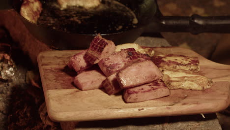 Delicious-thick-slices-of-ham-and-cheese-from-campfire-pan-onto-board
