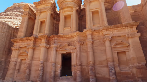 Close-up-tilt-up-shot-of-Ad-Deir-facade-on-sunny-day,-The-Monastery,-Petra,-Jordan