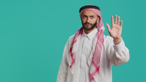 Middle-eastern-guy-doing-stop-gesture