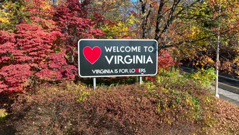 Welcome-to-Virginia-state-sign-among-colorful-autumn-foliage