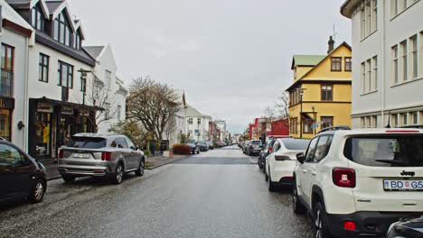 Long-empty-street-with-parked-cars-in-downtown-Reykjavik-in-autumn